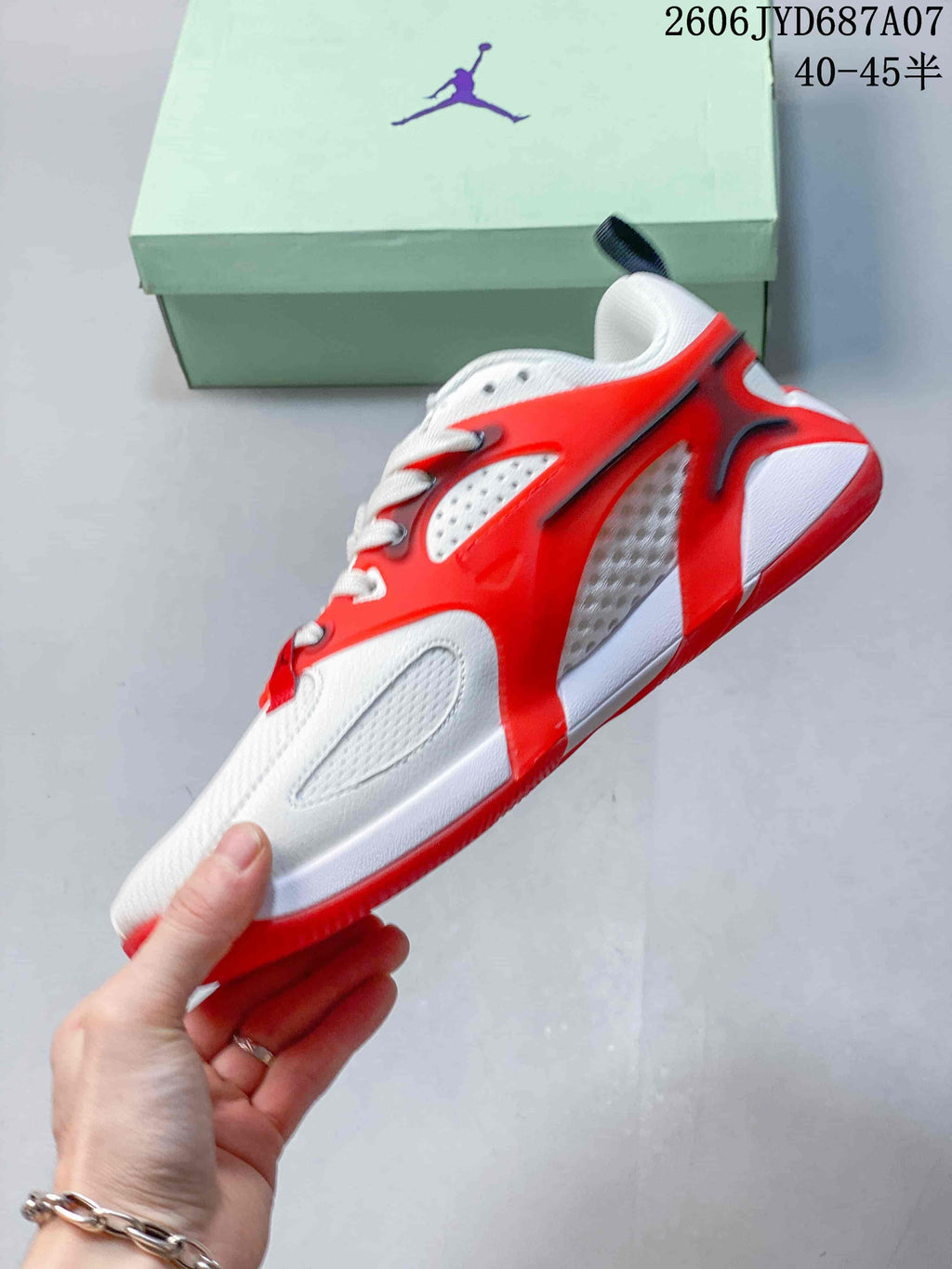 Side view showing the perforated panels and red overlays on a Jordan Heir PF shoe