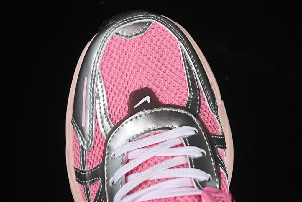 Top-down view of the pink mesh-look toe, silver-look overlays, and white laces