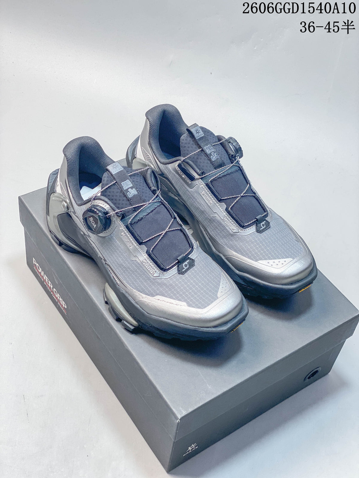 Gray and dark navy KAILAS FUGA DU2 BOA trail shoes with dial closure, shown from the front on a shoebox.