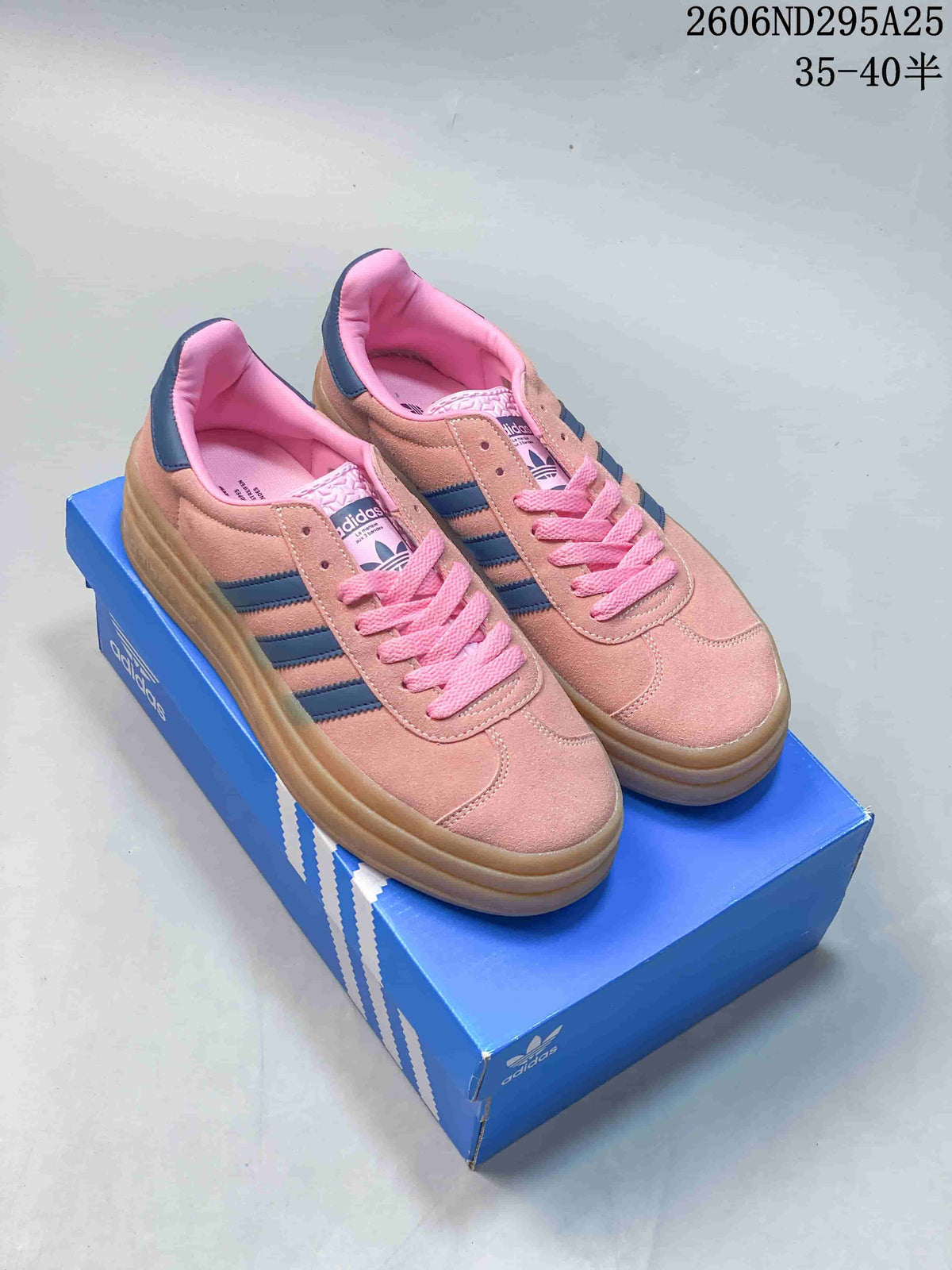 Pair of pink Adidas Gazelle Bold W sneakers with navy stripes, pink laces and layered gum-look platform soles
