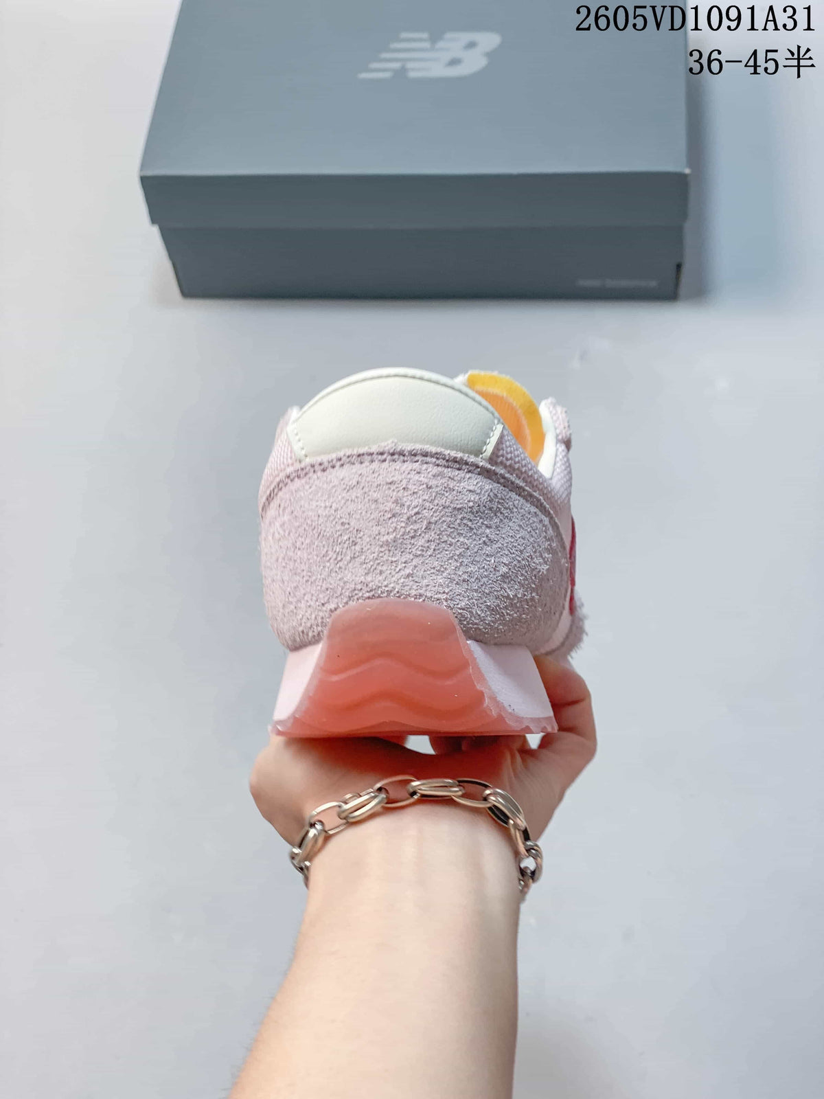 Rear view of a pale pink New Balance 471 sneaker showing the heel and outsole.