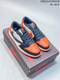 Pair of low-top sneakers in orange, navy, and white on a shoebox