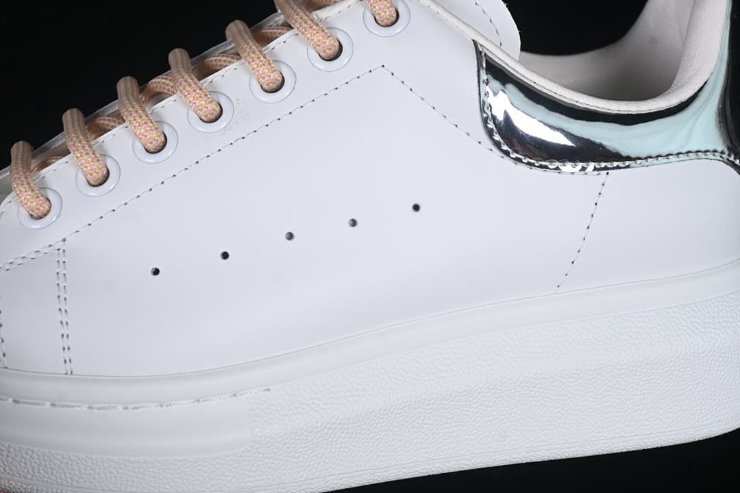 Close-up of the white side panel, patterned laces, and reflective heel detail