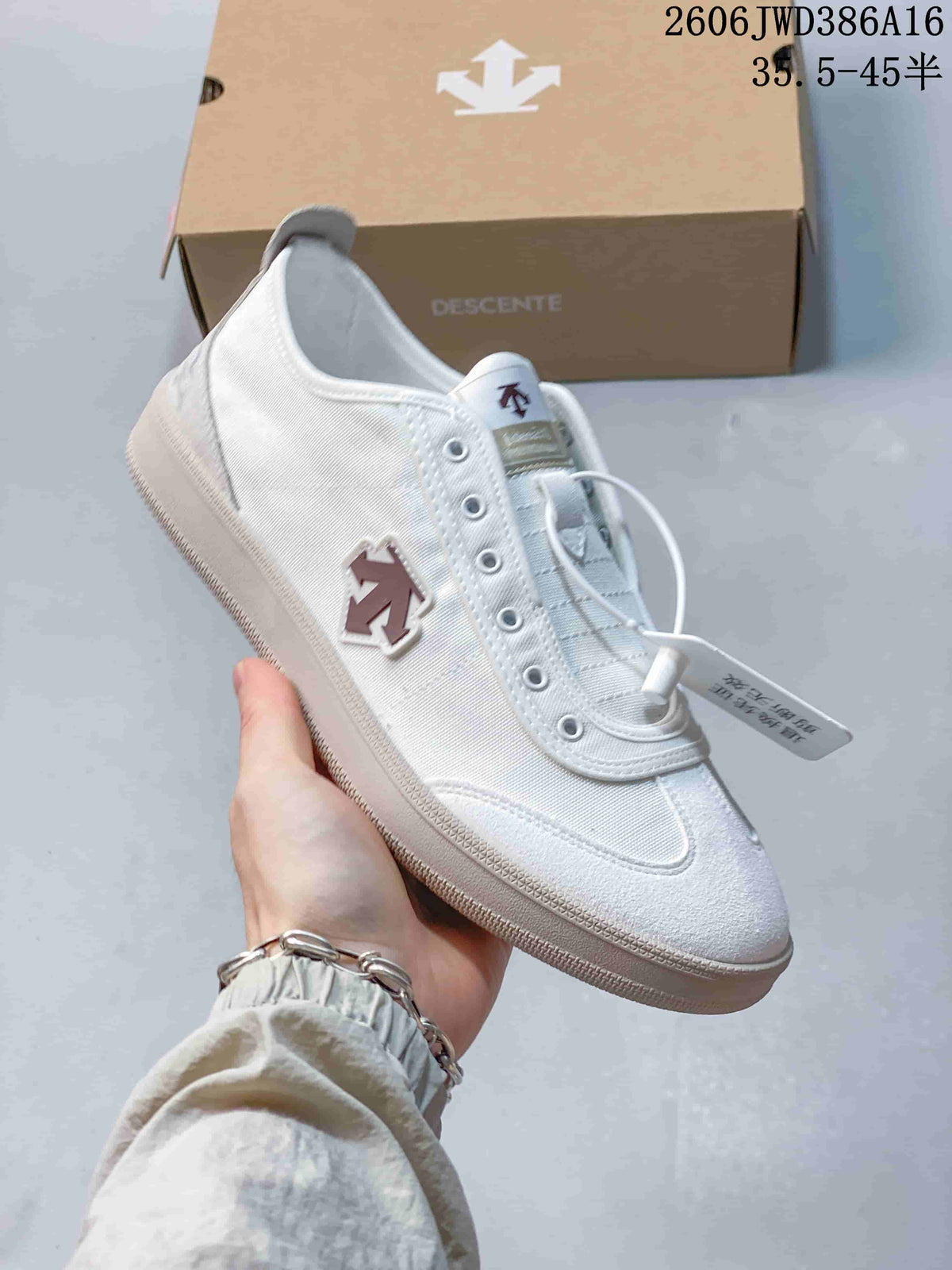 Angled side view of the white sneaker with a contrasting logo emblem
