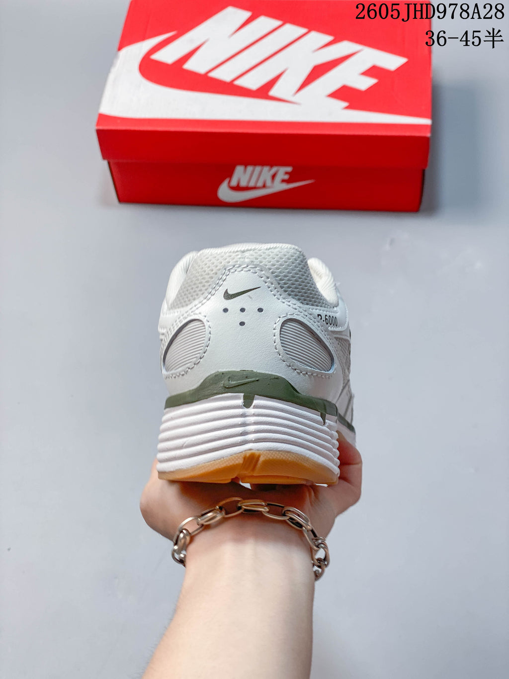 Rear view of the Nike Initiator shoe with olive-toned heel accents