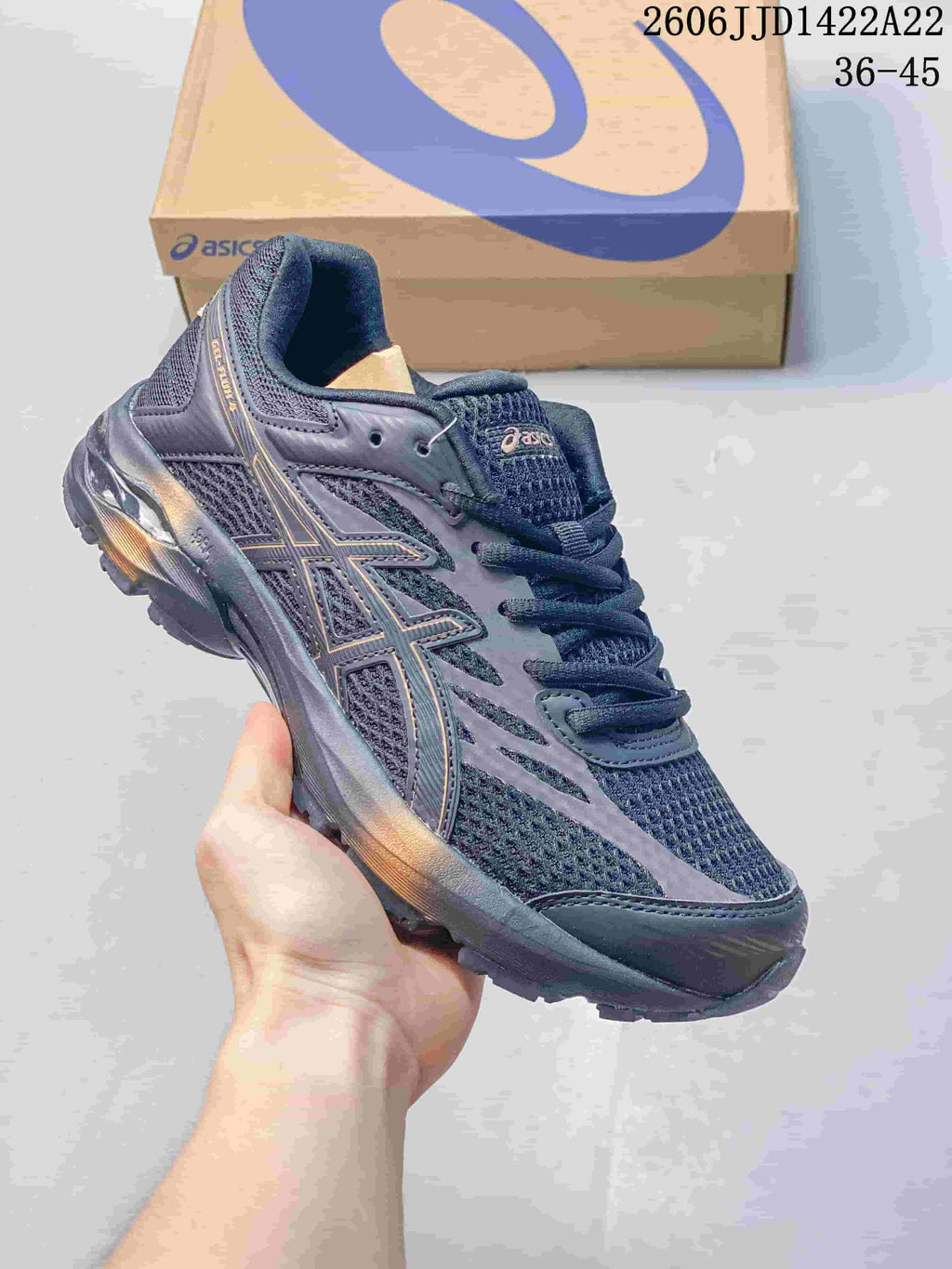Dark charcoal ASICS GEL-FLUX shoe with mesh panels and subtle contrasting details.