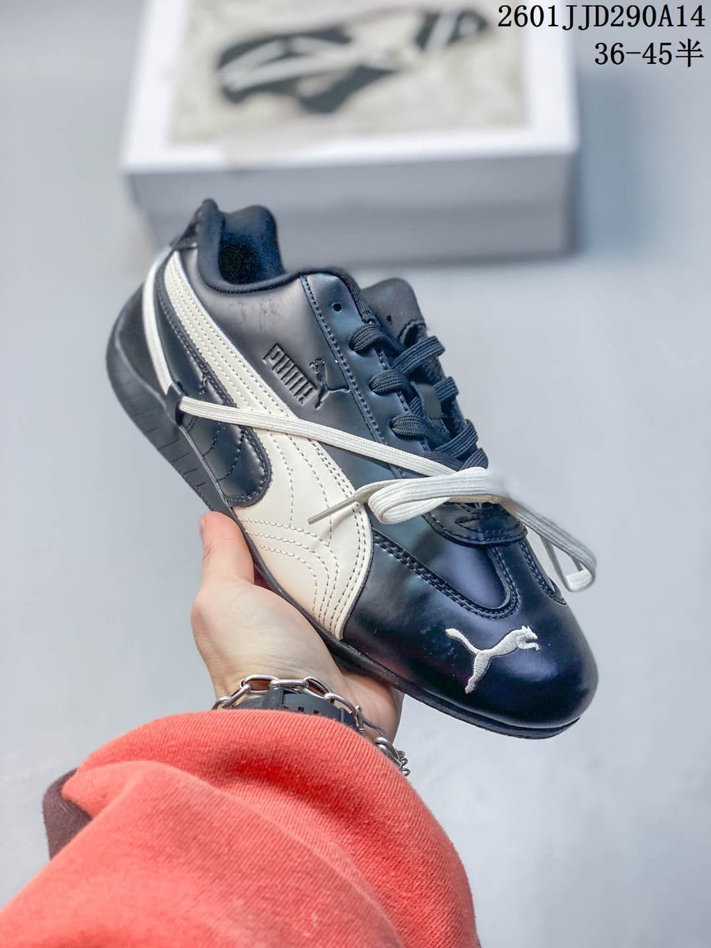 Side view of a navy PUMA Speedcat TTF sneaker with cream side stripes and decorative crossover laces.
