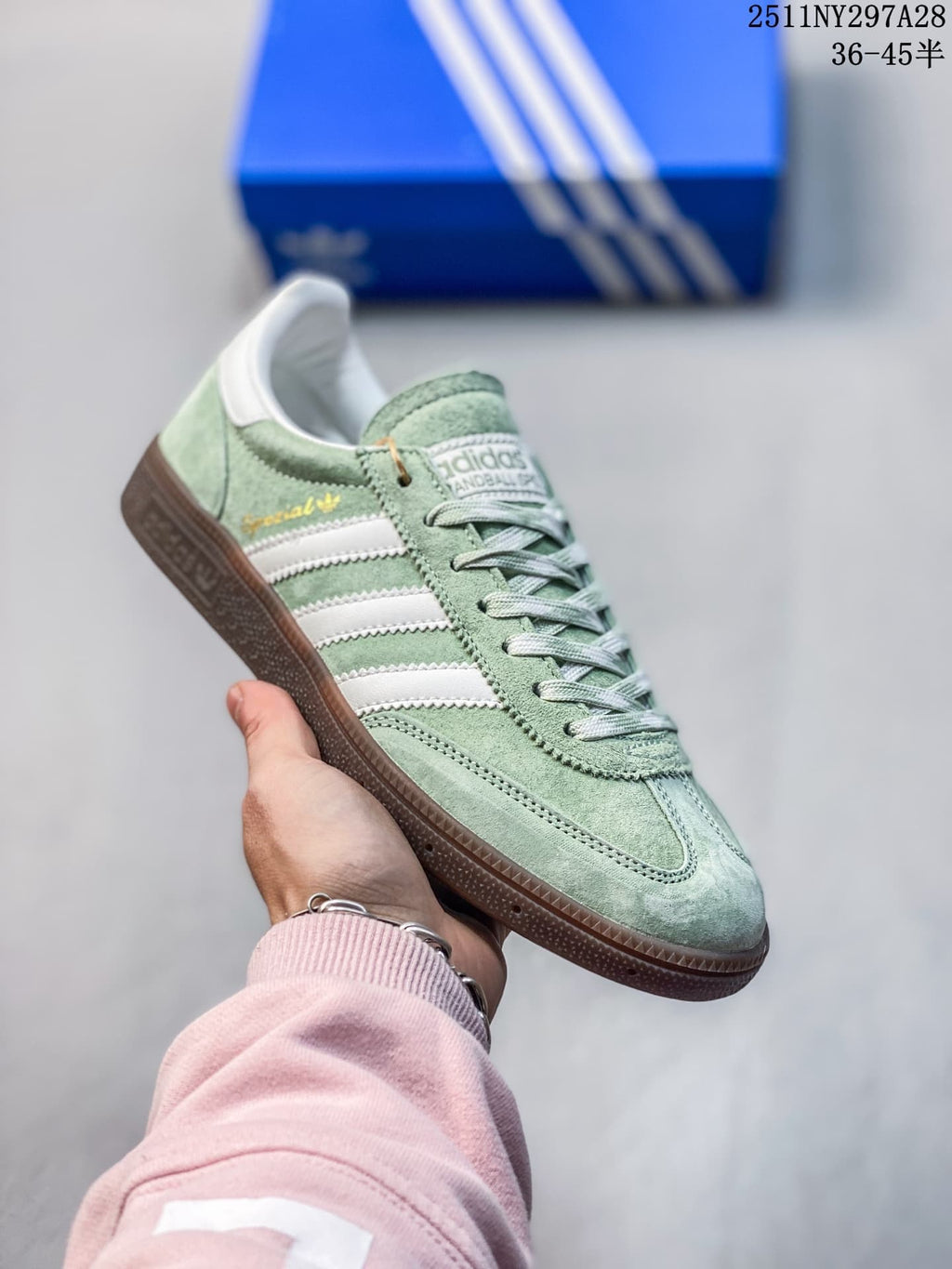 Angled side view of a pale green adidas Handball Spezial sneaker with white stripes and a brown outsole.