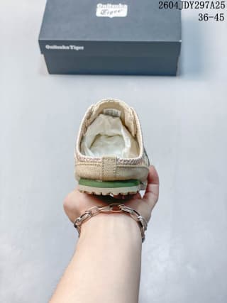 Rear view of the sneaker showing the heel area and green outsole accent.