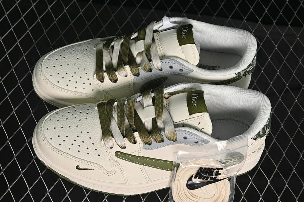 Top view of a pair of low-top sneakers showing perforated toes, olive and light laces, and patterned heel accents.