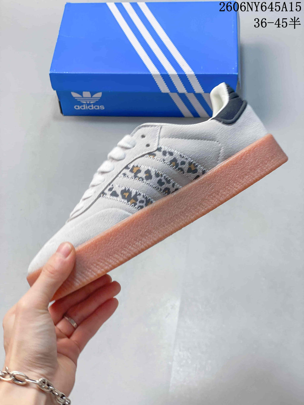 Side view of the light gray sneaker with patterned stripes and a chunky gum-colored sole