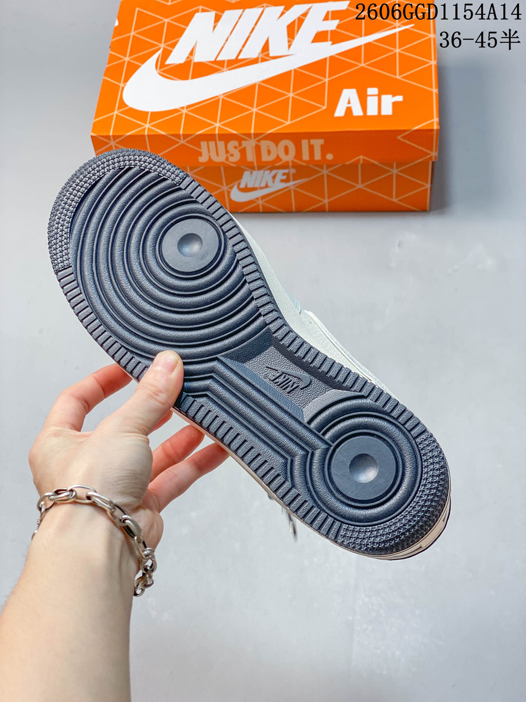 Close-up of the dark circular-pattern outsole of a Nike Air Force 1 sneaker