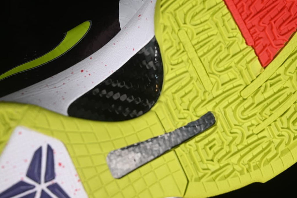 Close-up of the yellow-green outsole tread and side details.