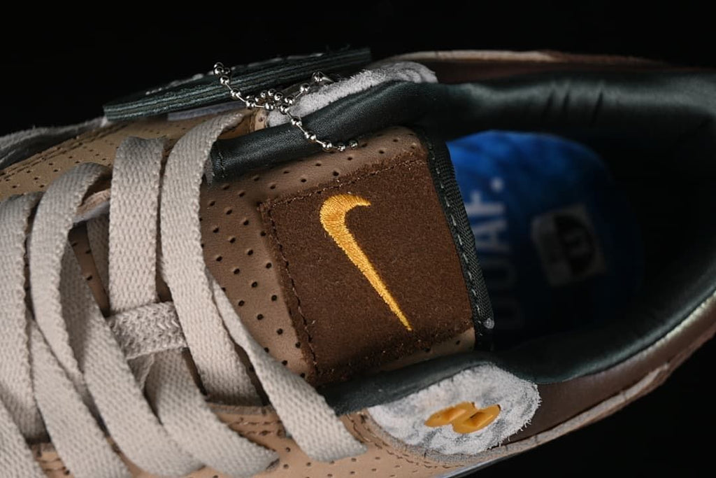 Top detail of the tongue, laces, and gold embroidered Swoosh