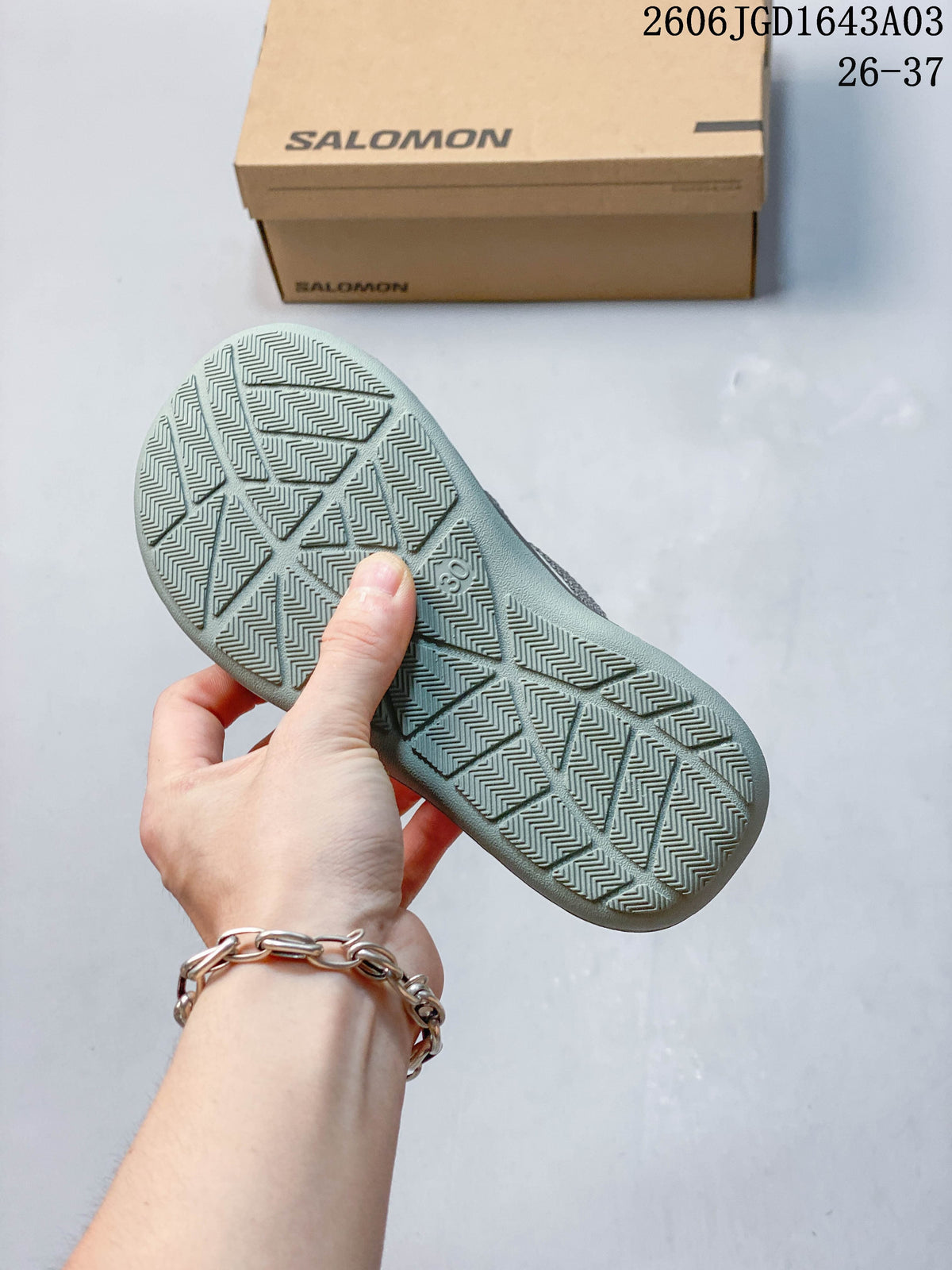 Close-up of the patterned outsole on a Salomon kids’ sneaker.