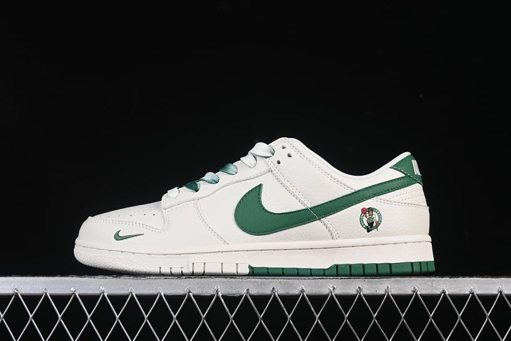 Side view of white and green Nike SB Dunk Low sneakers with a Celtics-themed heel graphic