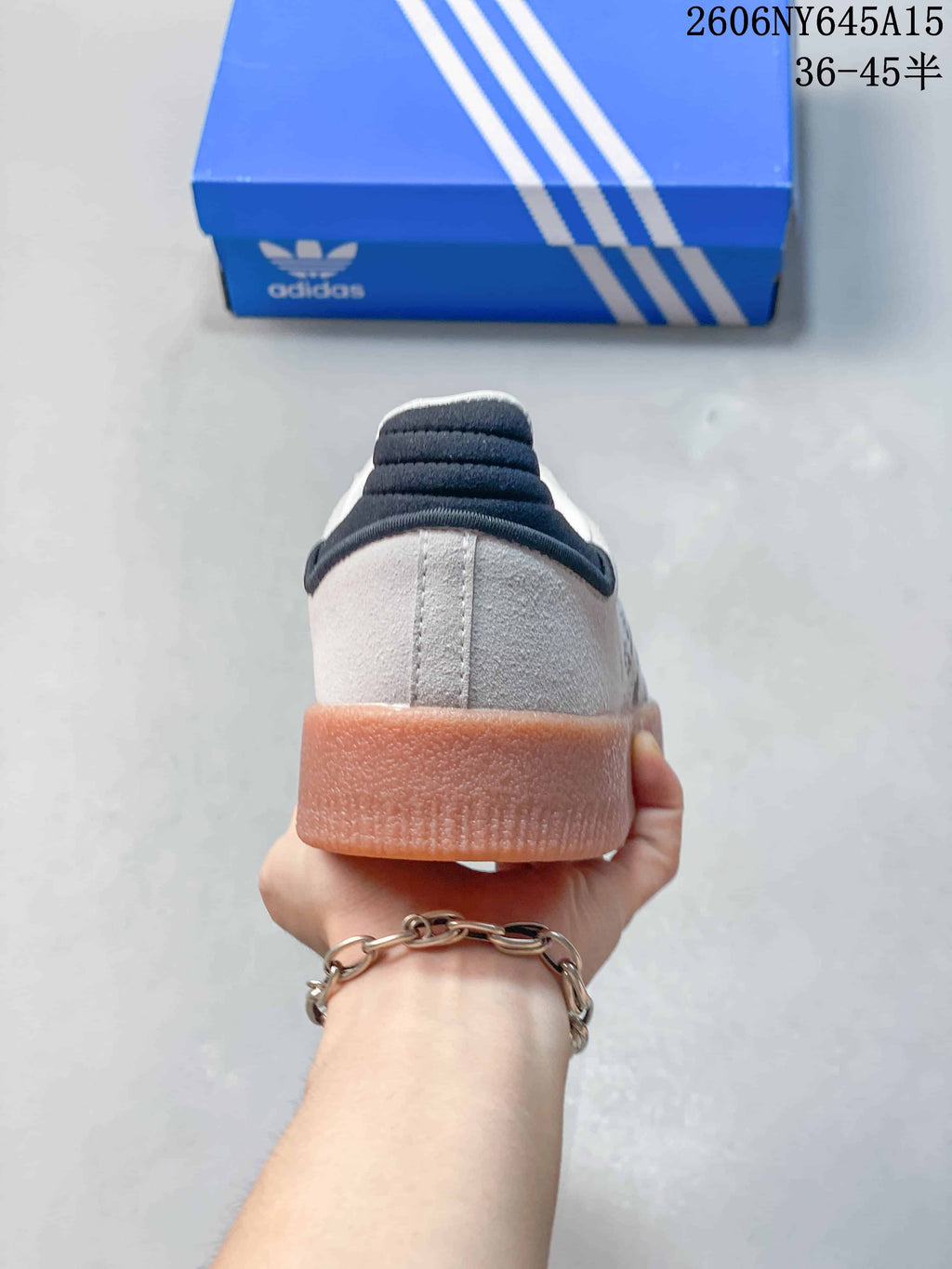 Rear view of the sneaker showing the dark heel detail and gum-colored sole