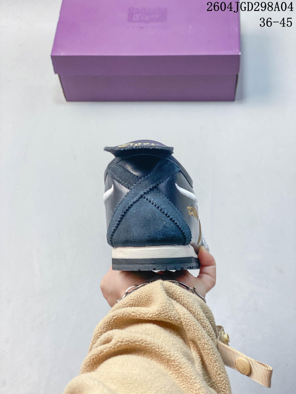 Rear view showing the heel construction and layered sole of a navy sneaker