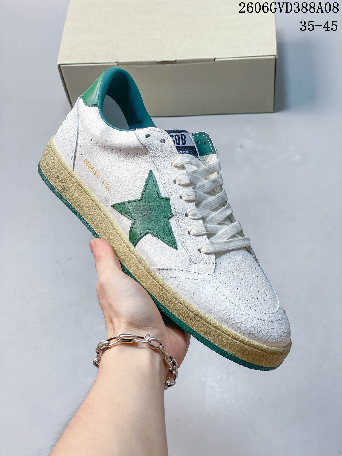 Angled side view showing the green star, white upper and teal heel accents