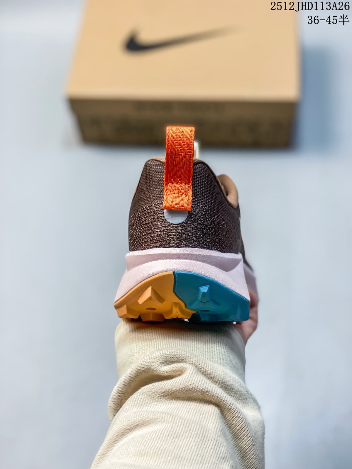 Rear view of the Nike ReactX Wildhorse 10 showing its orange heel pull tab and two-tone outsole.