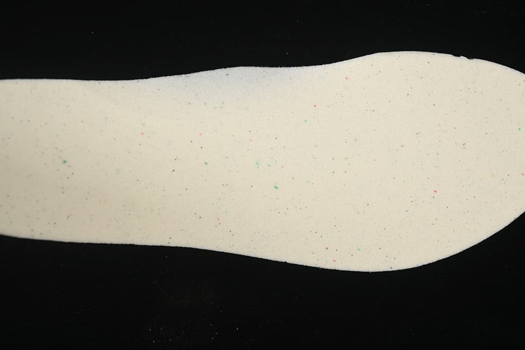 Light-colored shoe insert shown against a black background