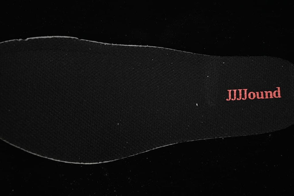 Black shoe insert with red JJJJound lettering