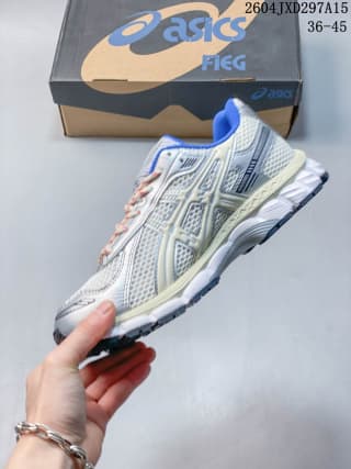 Side view of the ASICS sneaker showing layered panels, mesh-like sections, blue detailing, and the sculpted sole.