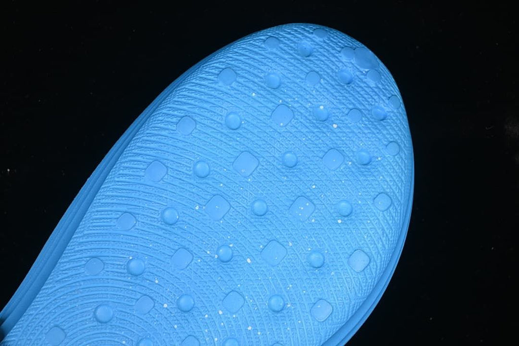 Close-up of the textured outsole and tread on the blue clog