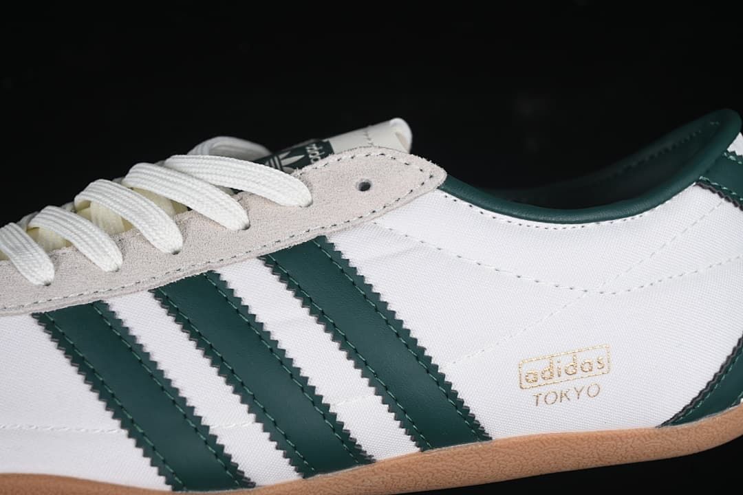 Close-up of the white upper, dark green stripes, gray eyelet overlay and Tokyo side marking