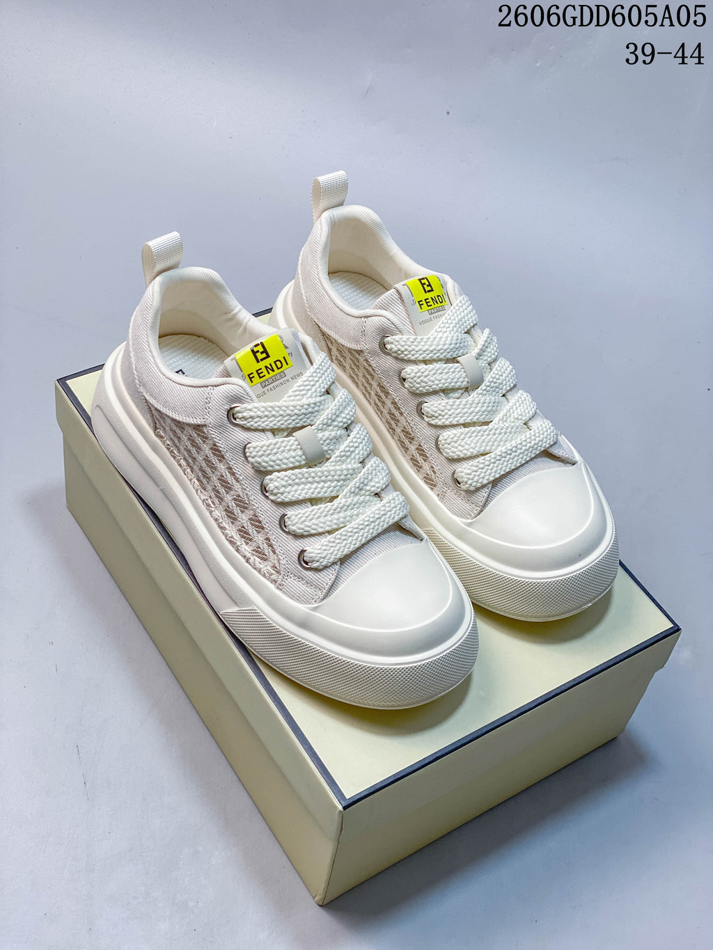 Pair of cream lace-up sneakers with patterned side panels and thick soles