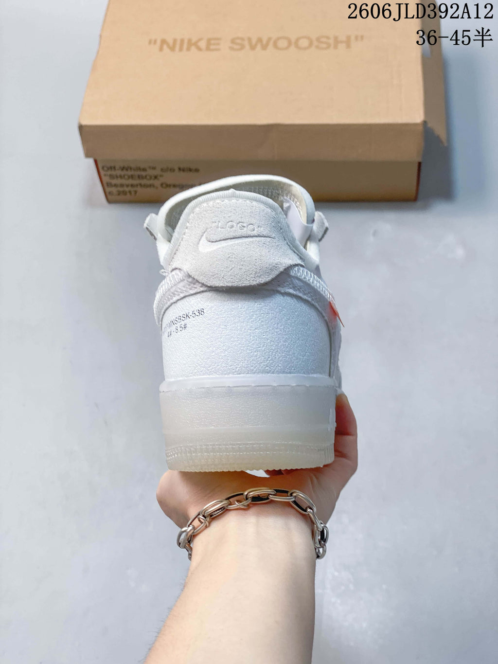 Rear view of a white sneaker with gray heel overlay
