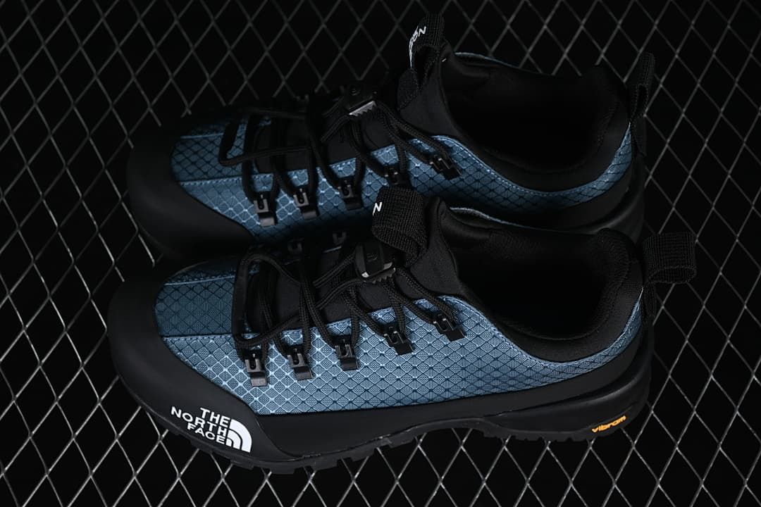 Pair of blue and black shoes shown from above and the side.