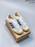 White and light grey adidas Samba sneakers with blue stripes and gum-look soles, shown on a shoebox