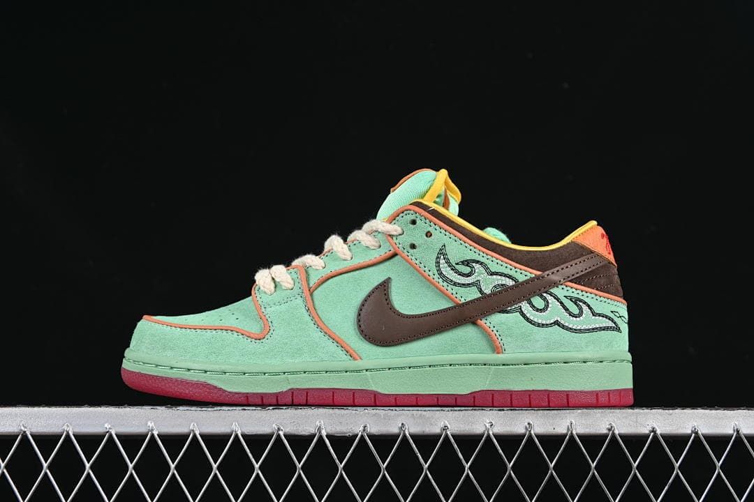 Side view of mint green Nike SB Dunk Low sneakers with brown, coral, yellow, and red accents.