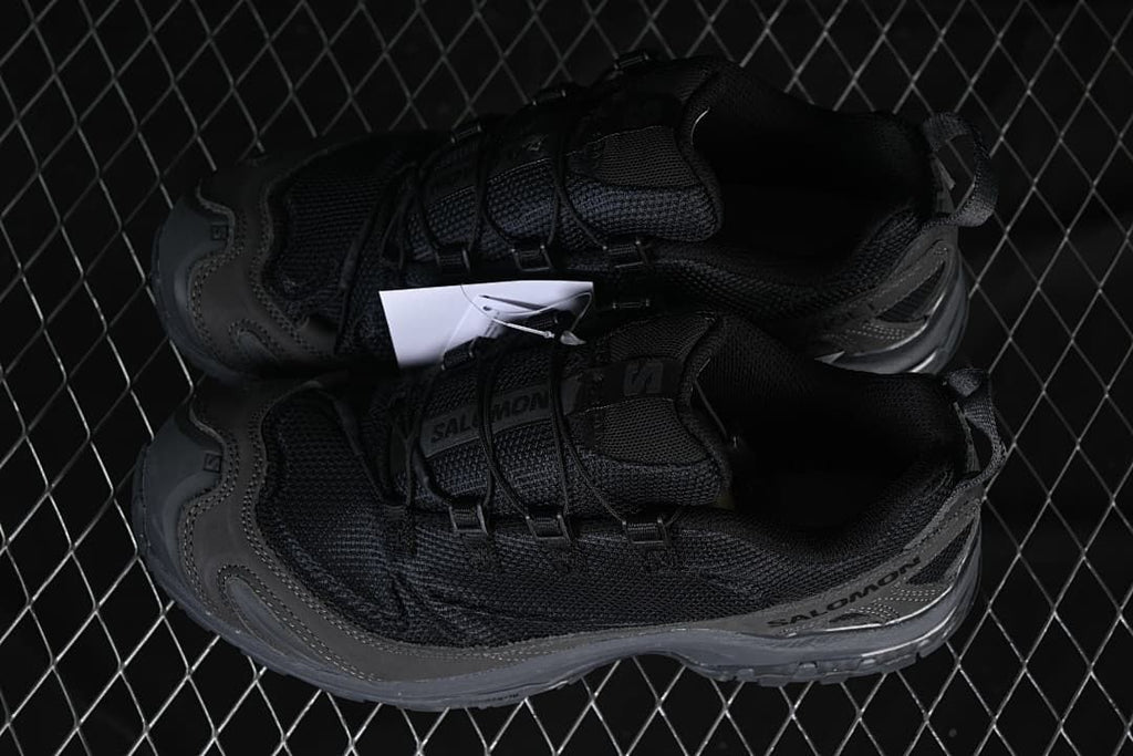 Pair of black and dark grey trail shoes viewed from above