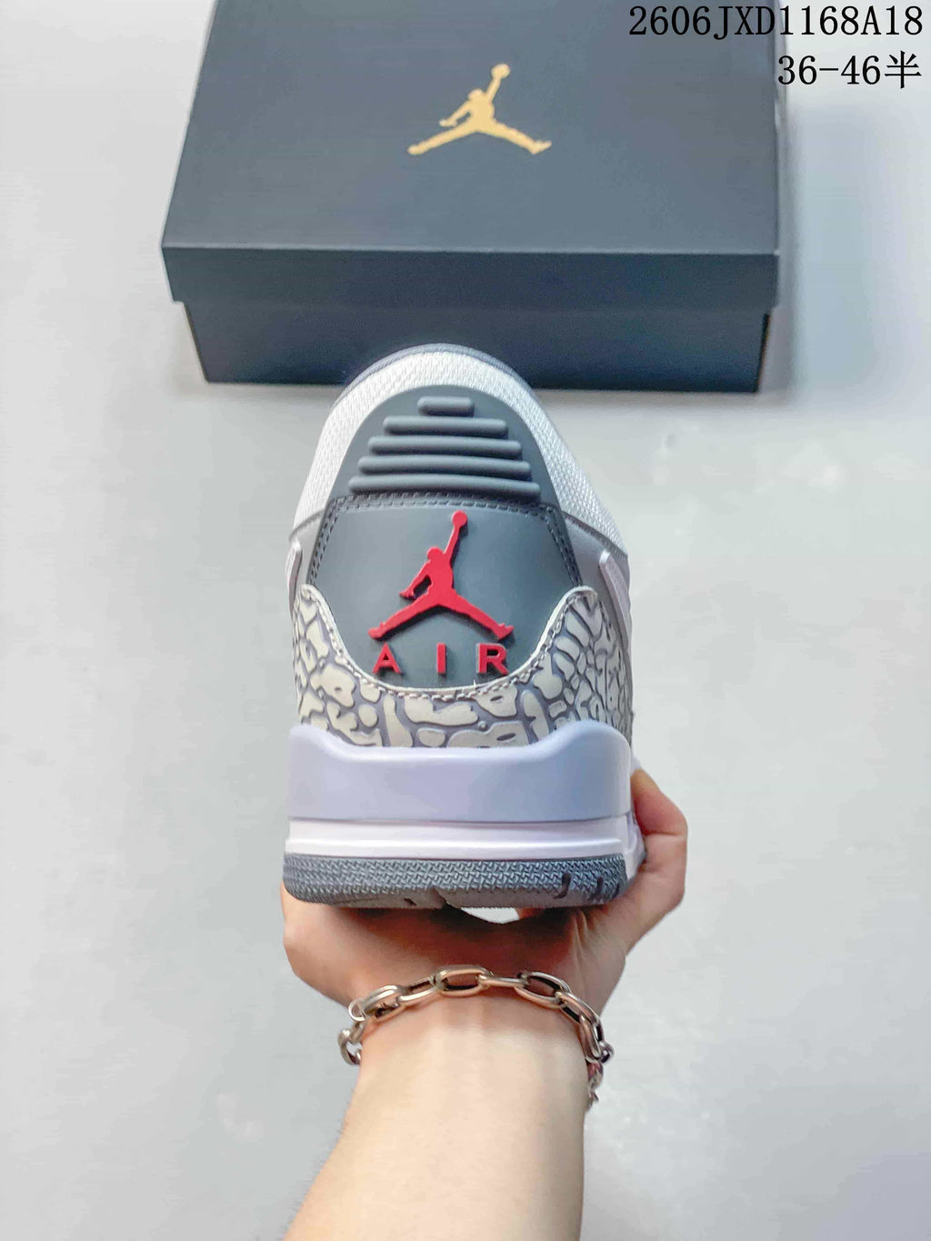 Rear view showing the patterned heel panel and red emblem on a Jordan Legacy 312 sneaker