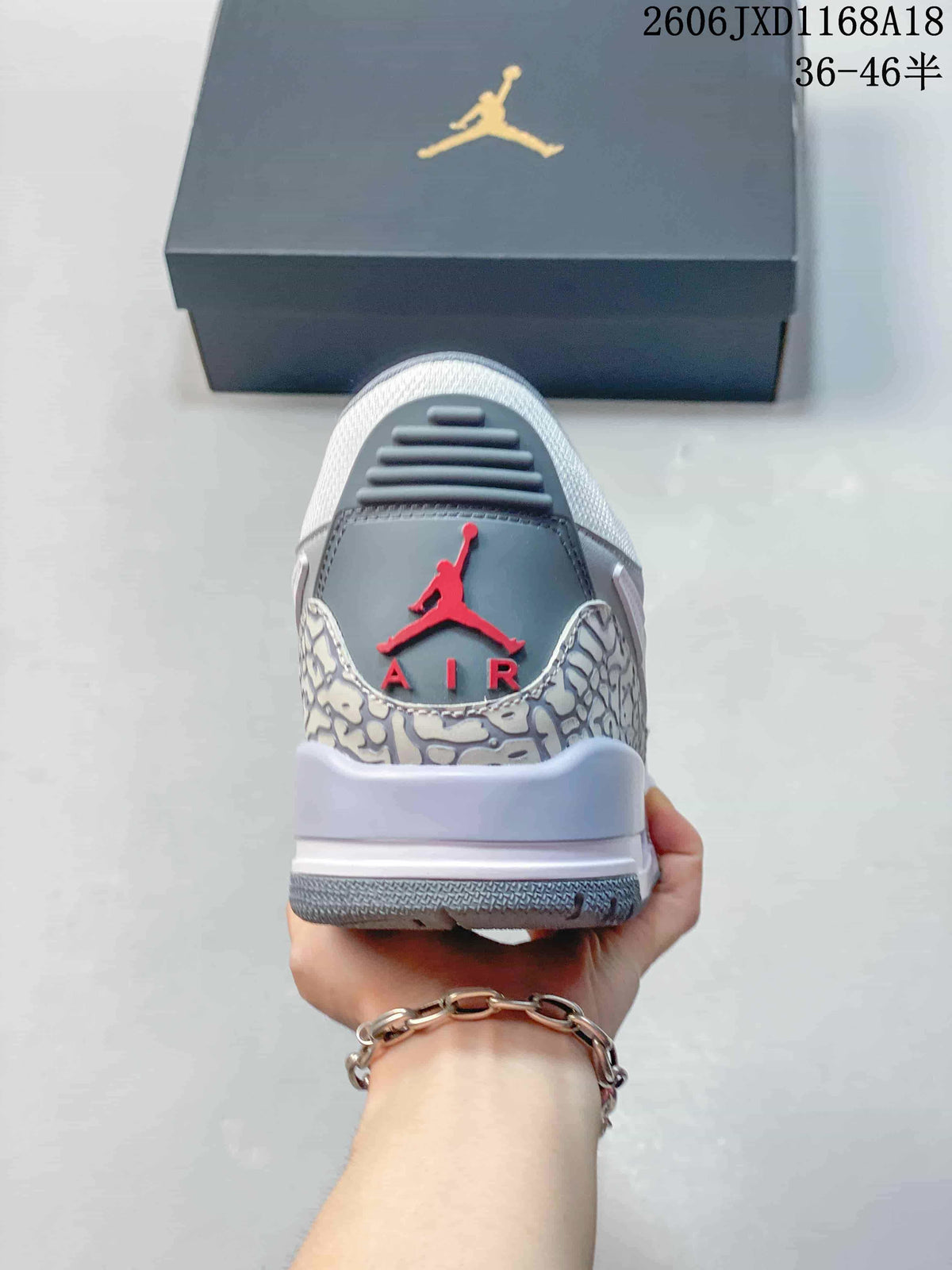 Rear view showing the patterned heel panel and red emblem on a Jordan Legacy 312 sneaker
