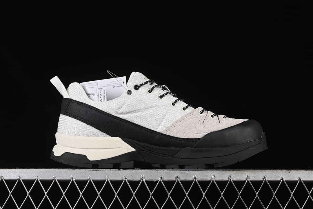 Side profile of the sneaker with a black toe overlay and lugged outsole