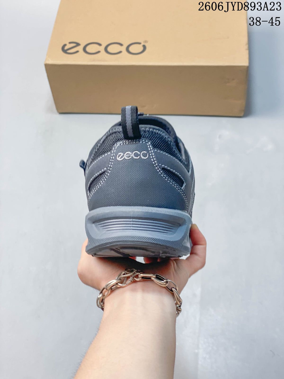 Rear view of a gray ECCO shoe showing the heel and pull tab