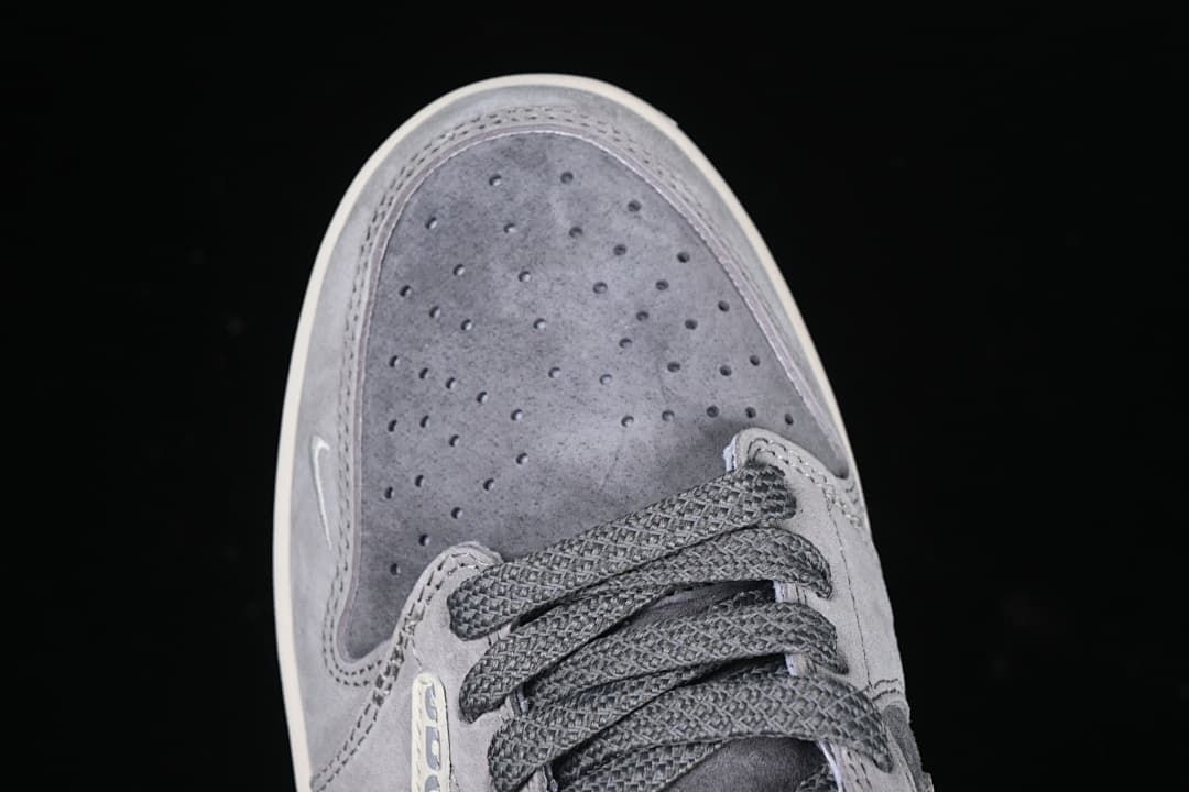 Top view of perforated gray toe box and laces