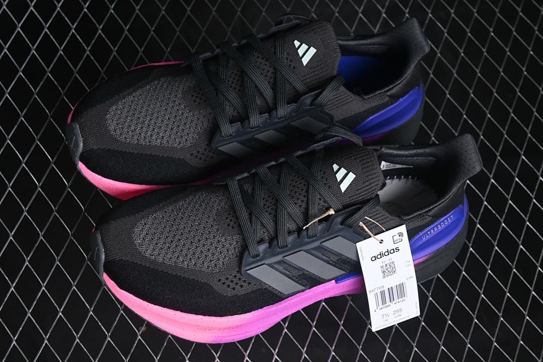 Pair of black running shoes with pink and blue-purple accents