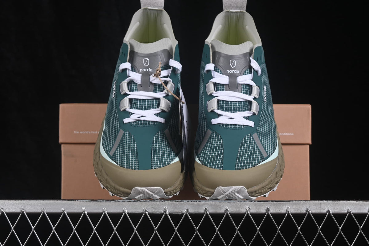 Front view of the pair showing white laces, patterned uppers, tan toe guards, and contrasting midsoles.