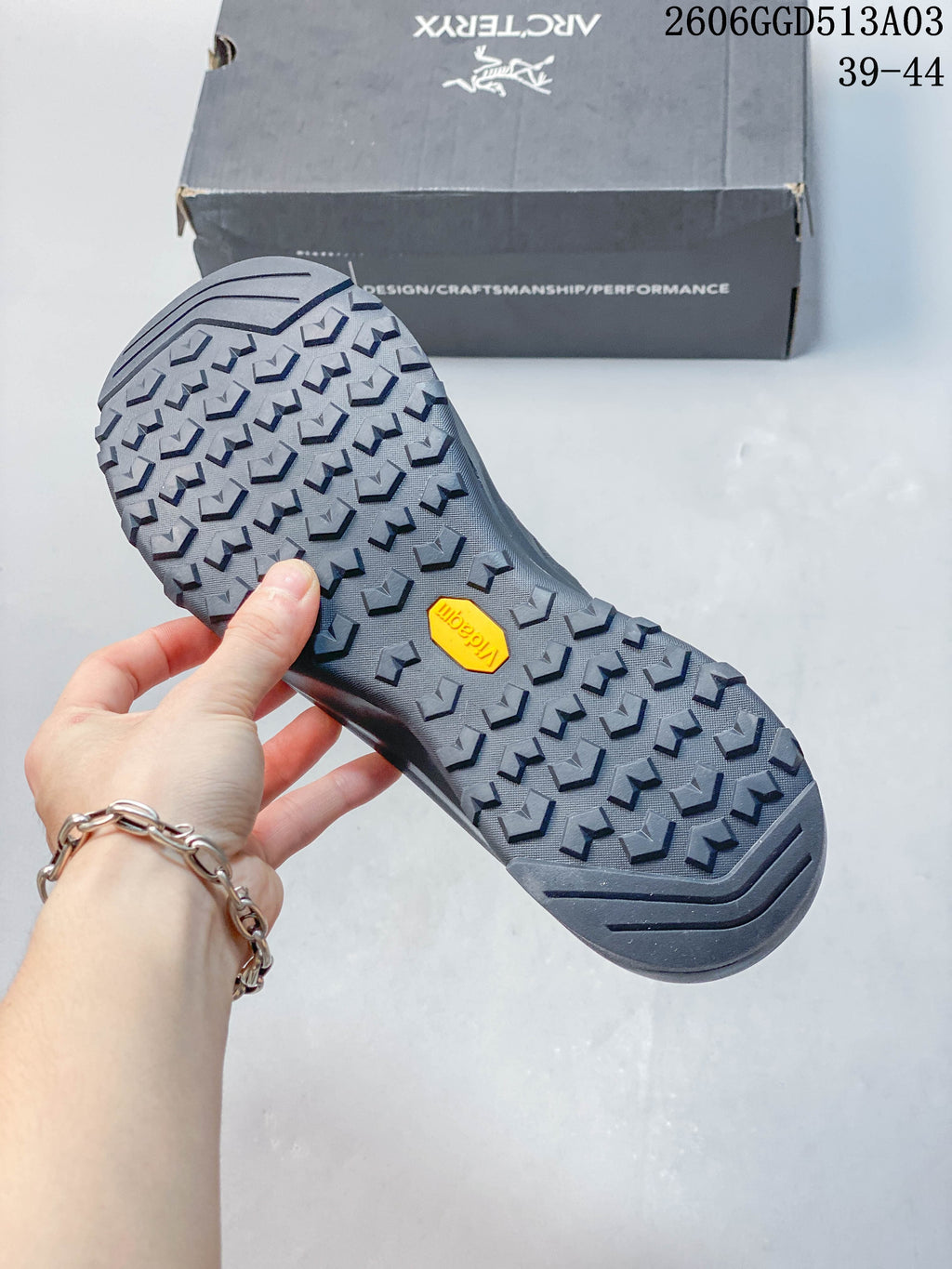 Close-up of the lugged outsole with a yellow Vibram mark