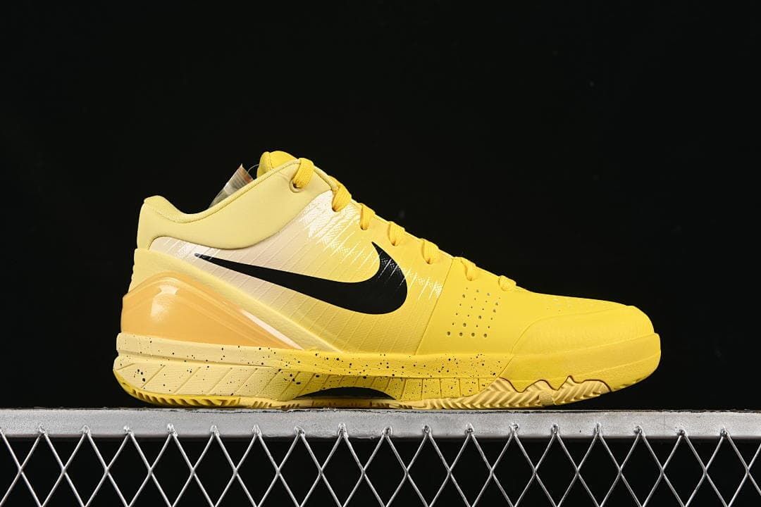 Side profile of the yellow shoe with black Swoosh