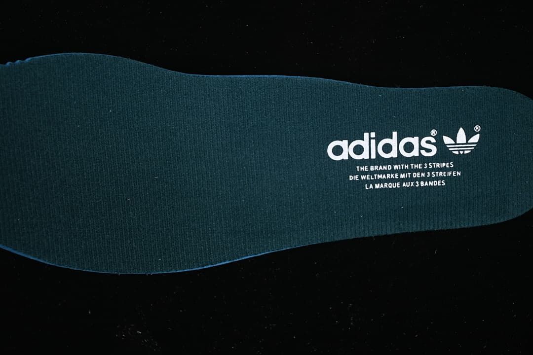Dark green adidas insole with trefoil branding