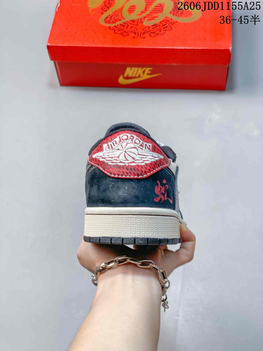 Rear view of the sneaker with a red heel panel and dark navy heel