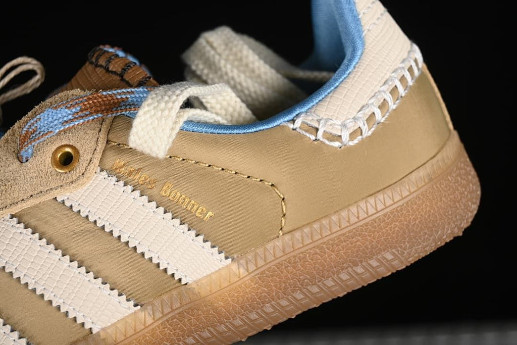 Close-up of tan heel panel, cream stripes, and gum-colored sole