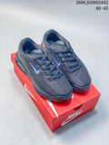 Pair of dark gray Nike Air Max BIA shoes with blue accents on a red shoebox