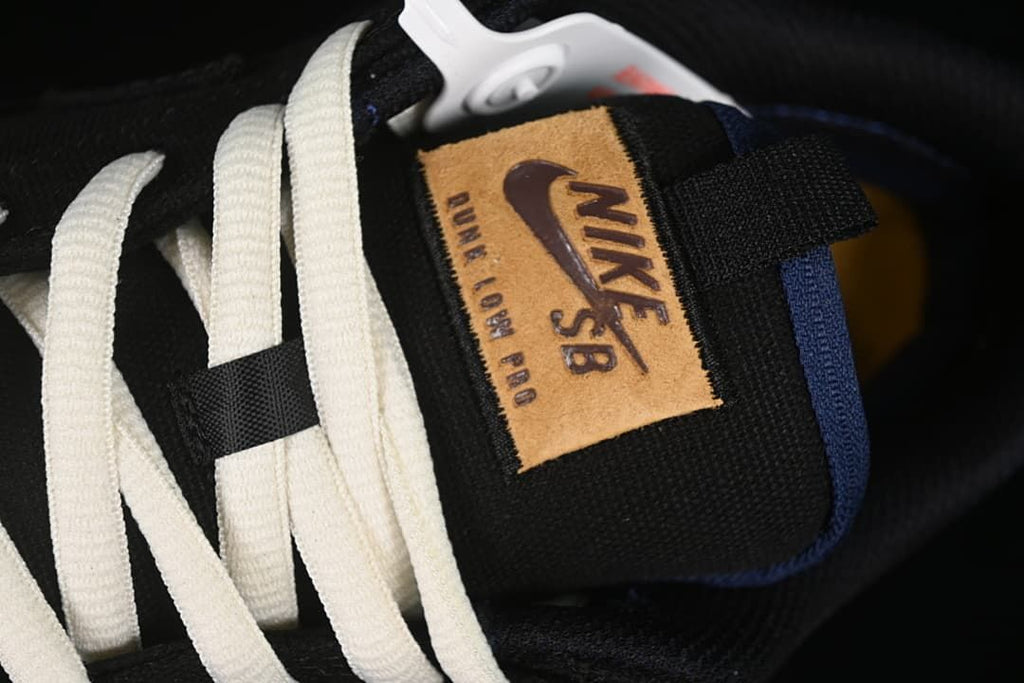 Close-up of the tongue label, white laces, and blue trim