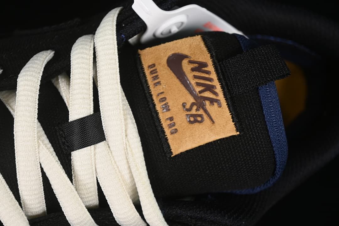 Close-up of the tongue label, white laces, and blue trim